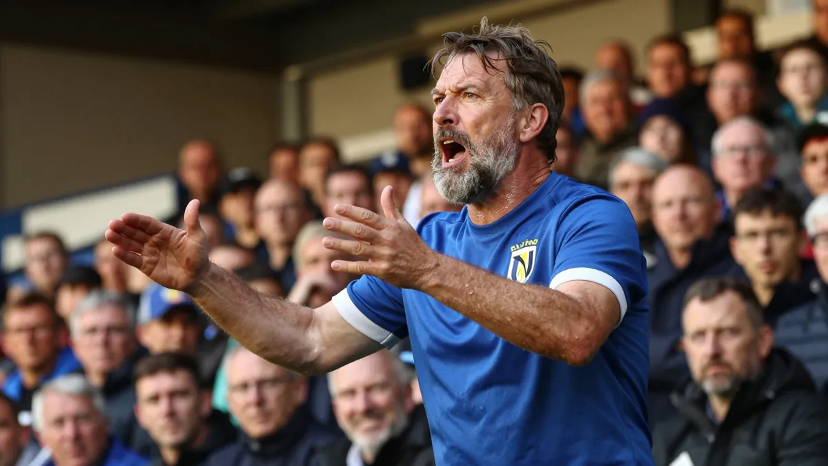 During a friendly match between Norwich City and Osasuna, one fan wearing an Ipswich Town shirt and orange wig sparked...